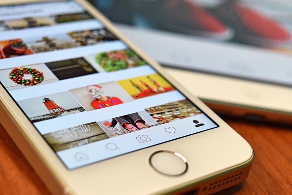Celular mostrando a grade de fotos de um perfil no Instagram